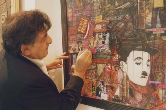 Aref El Rayess working on a large collage featuring Charlie Chaplin